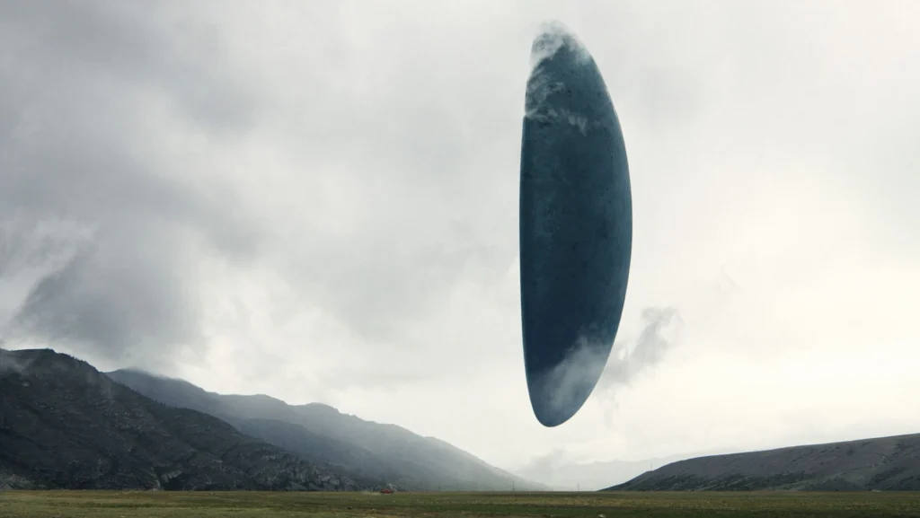 A shot of the alien spacecraft hovering above the landscape, creating a sense of wonder and tension