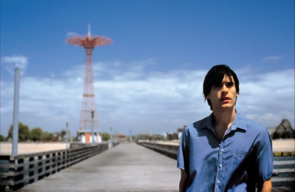 A lone figure standing on a deserted street, symbolizing isolation and despair