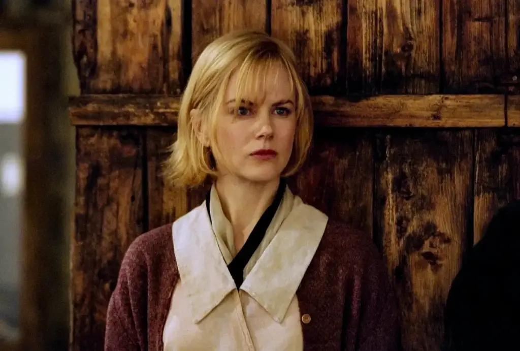 Grace in Dogville, dressed in simple clothes, represents innocence amidst darkness